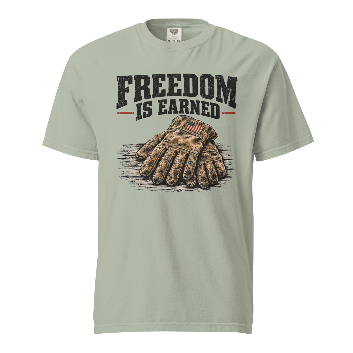 grey men's t-shirt with work gloves on a wooden surface, and above it says "Freedom is earned"