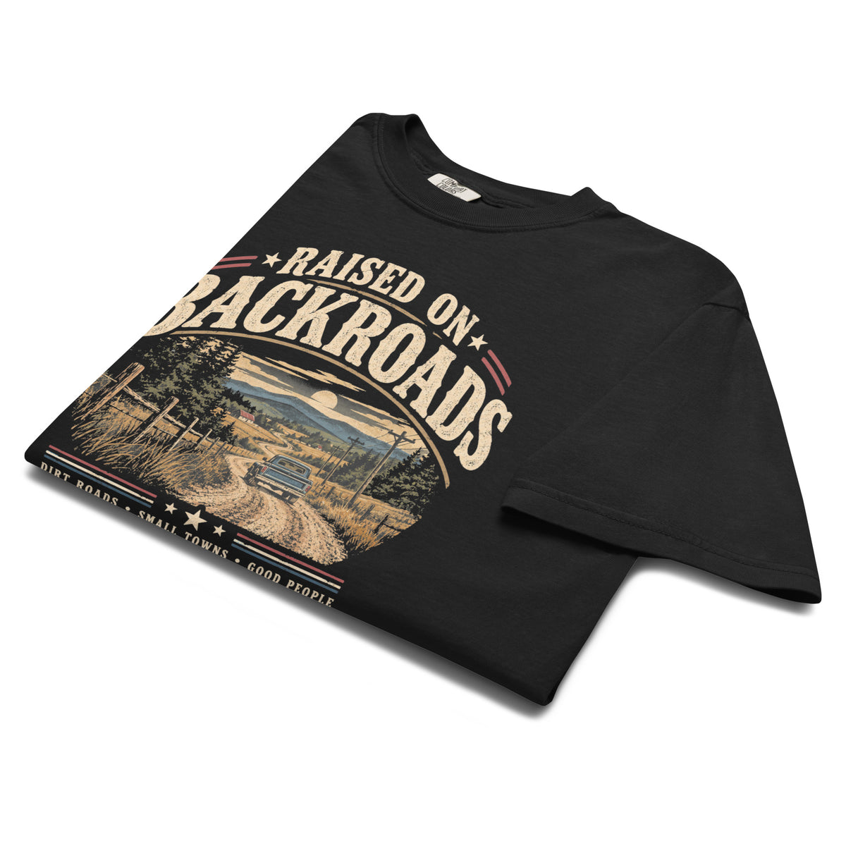 black men's t-shirt with text saying "Raised on backroads" above a dirt road with truck graphic, red, white and blue accents