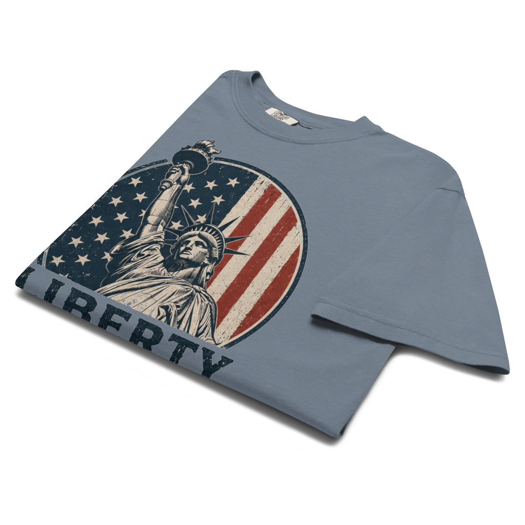 Blue men's t-shirt with American flag statue of liberty graphic, and text that says "Liberty isn't free" underneath