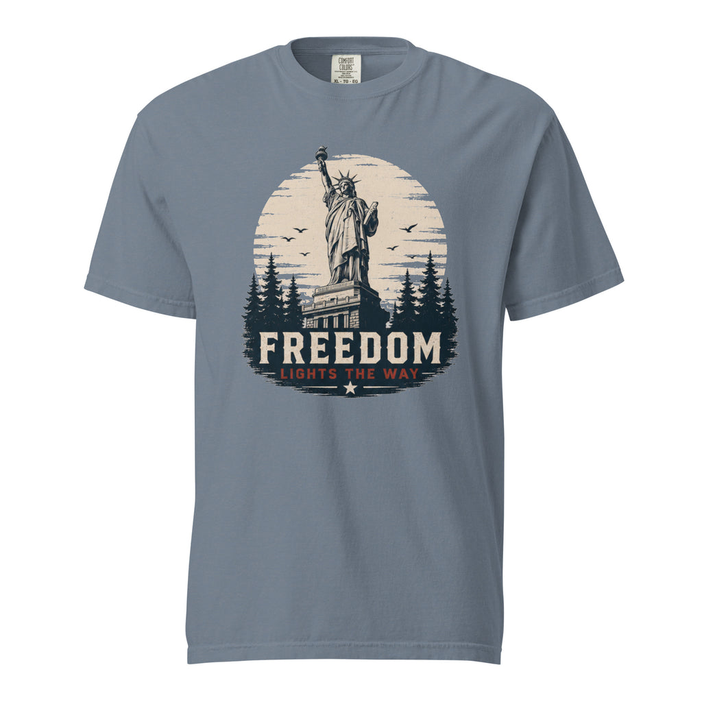 Blue men's t-shirt with statue of liberty and trees, that says "Freedom Lights the way" under it