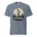 Blue men's t-shirt with statue of liberty and trees, that says "Freedom Lights the way" under it