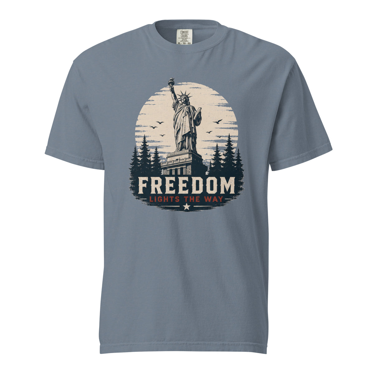 Blue men's t-shirt with statue of liberty and trees, that says "Freedom Lights the way" under it