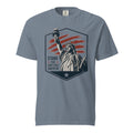 Blue men's t-shirt with statue of liberty and red stripes, that says "Stand for something greater" beside it