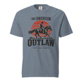 blue men's t-shirt with a sun setting silhouette and cowboy riding horse with "The American Outlaw" written above and below