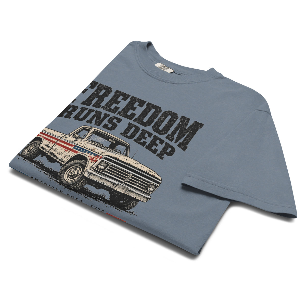 blue men's t-shirt with Freedom Runs Deep written across the top above a vintage American truck 