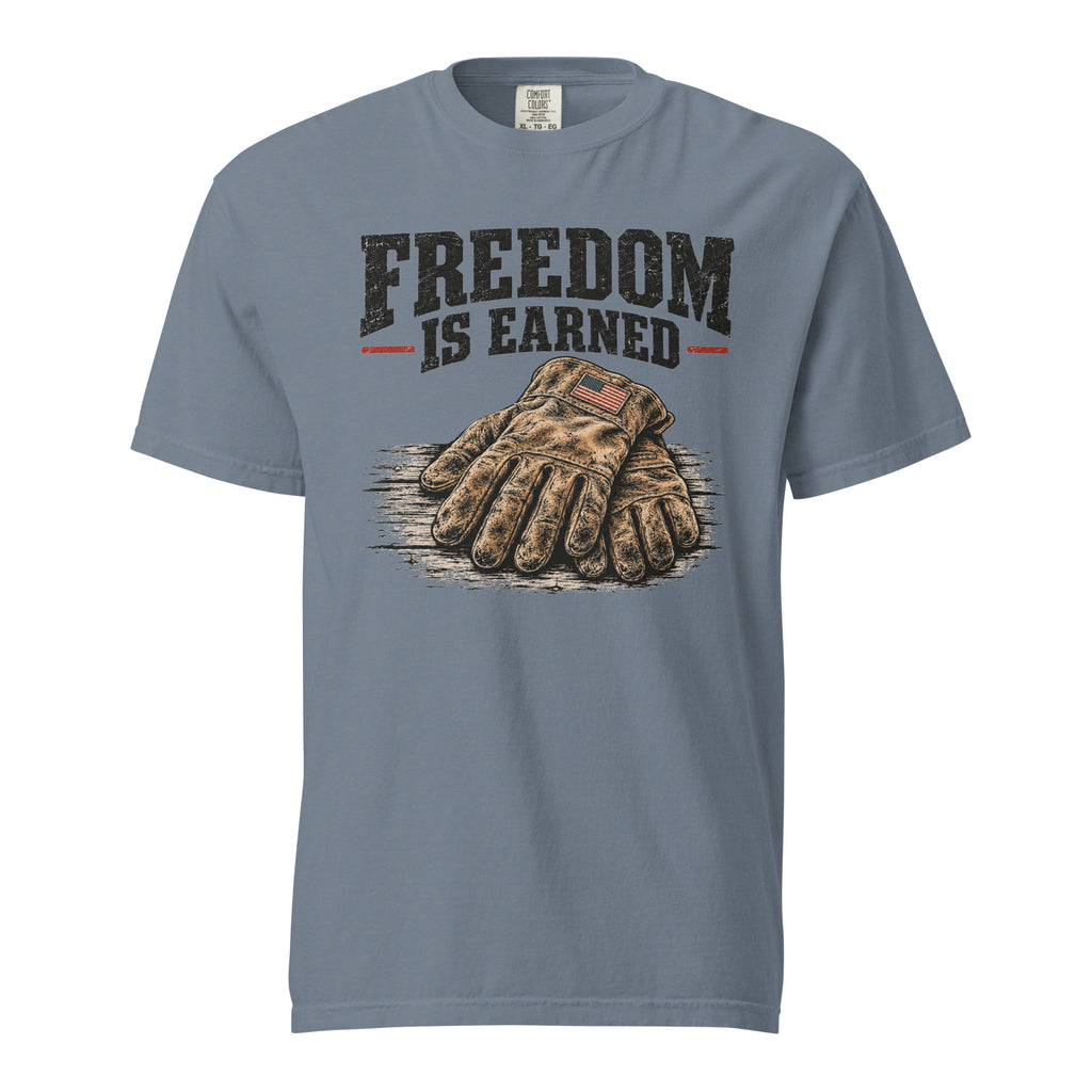 blue men's t-shirt with work gloves on a wooden surface, and above it says "Freedom is earned"