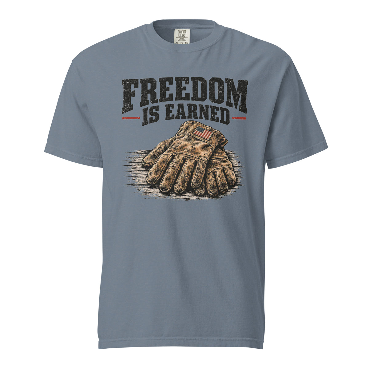 blue men's t-shirt with work gloves on a wooden surface, and above it says "Freedom is earned"