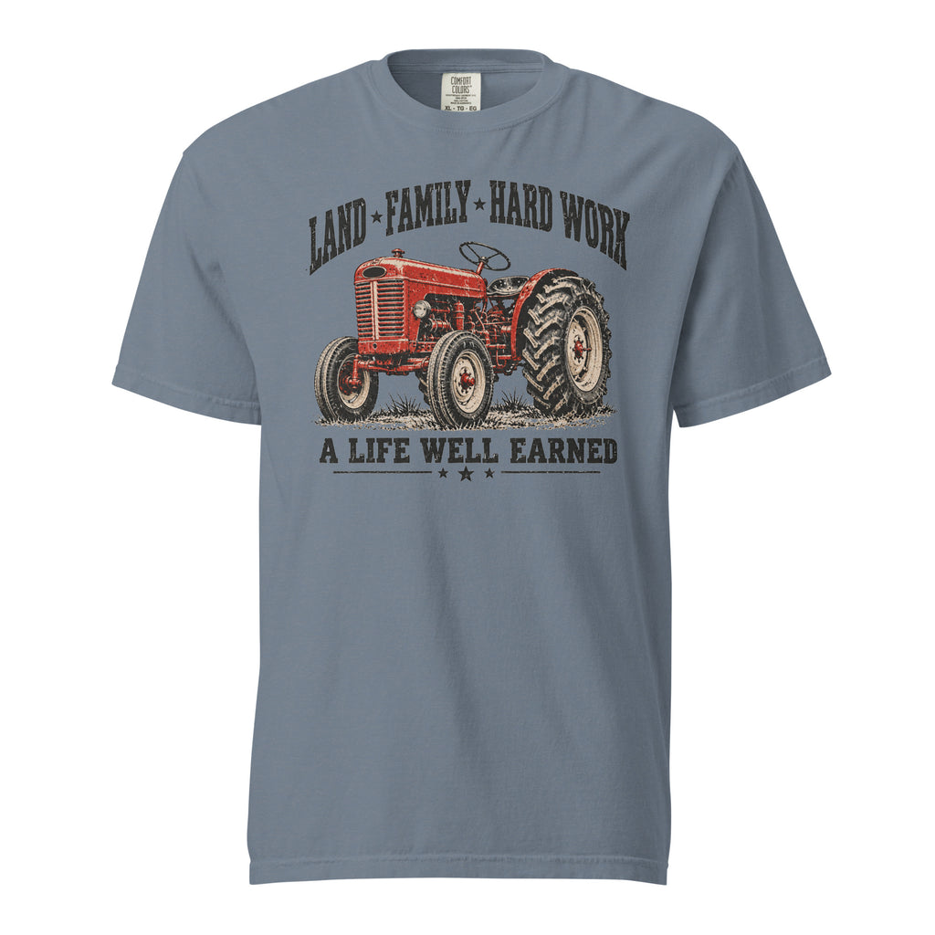 men's blue t-shirt with vintage red tractor graphic, and the words "land family hard work, a life well earned" written above and below