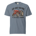 men's blue t-shirt with vintage red tractor graphic, and the words "land family hard work, a life well earned" written above and below