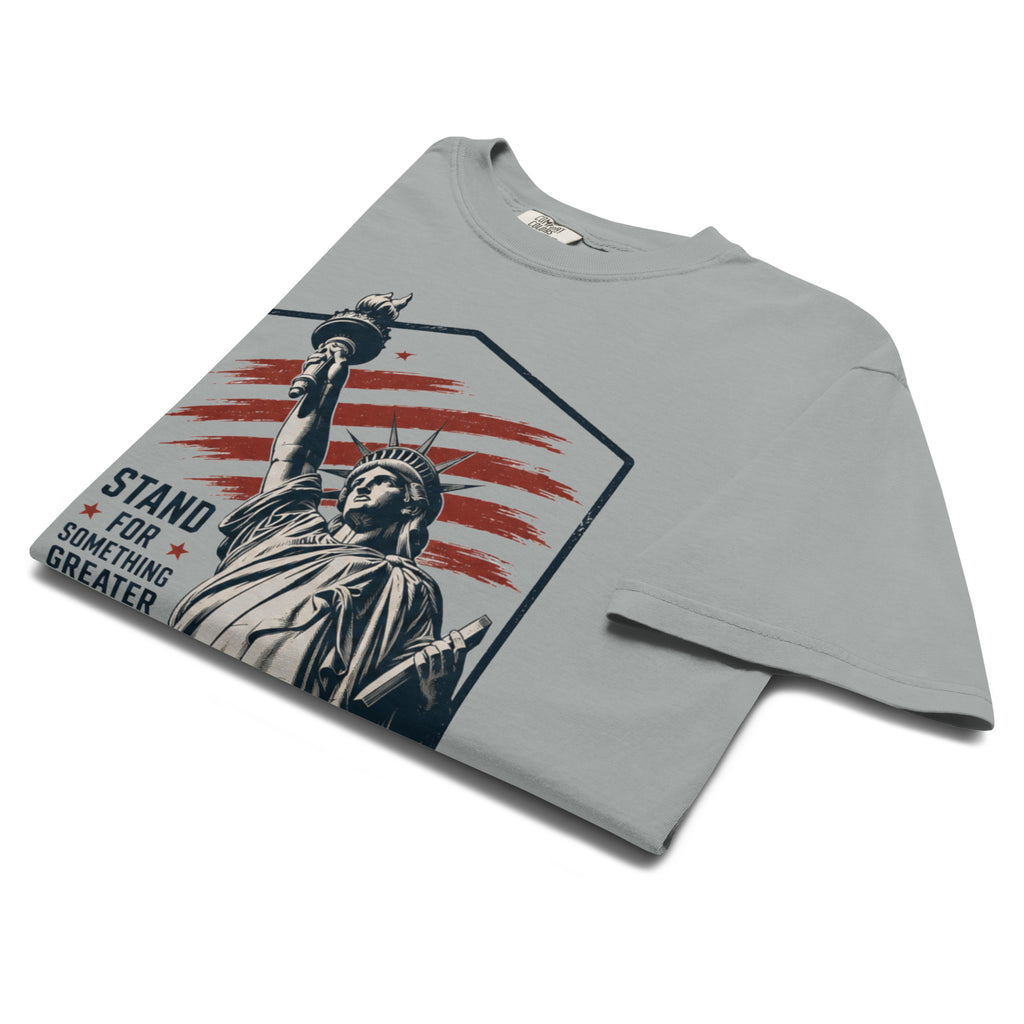 Gray men's t-shirt with statue of liberty and red stripes, that says "Stand for something greater" beside it