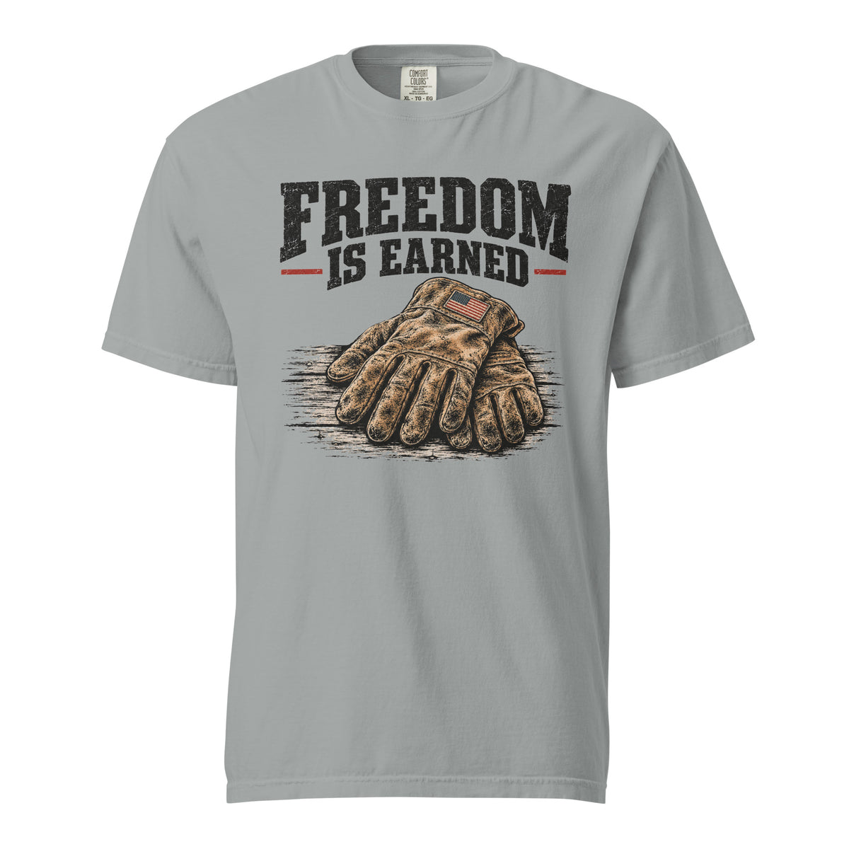 grey men's t-shirt with work gloves on a wooden surface, and above it says "Freedom is earned"