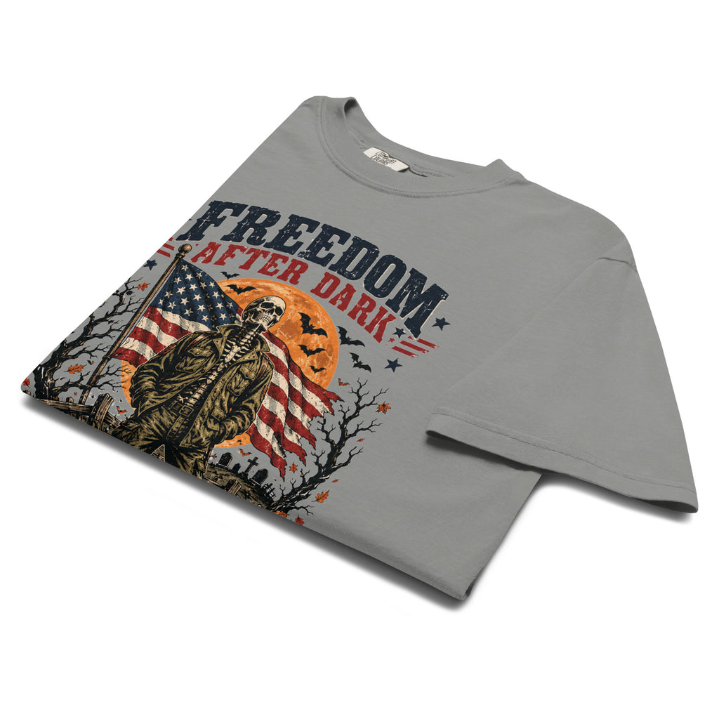 grey t-shirt with skeleton in front of American flag and moon, with Freedom after dark text above, and Halloween icon detail accents
