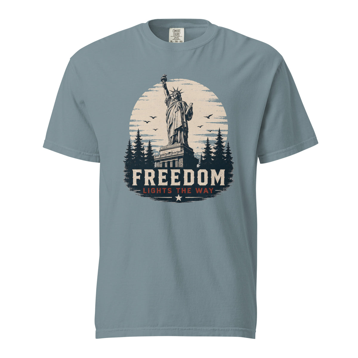 Blue men's t-shirt with statue of liberty and trees, that says "Freedom Lights the way" under it