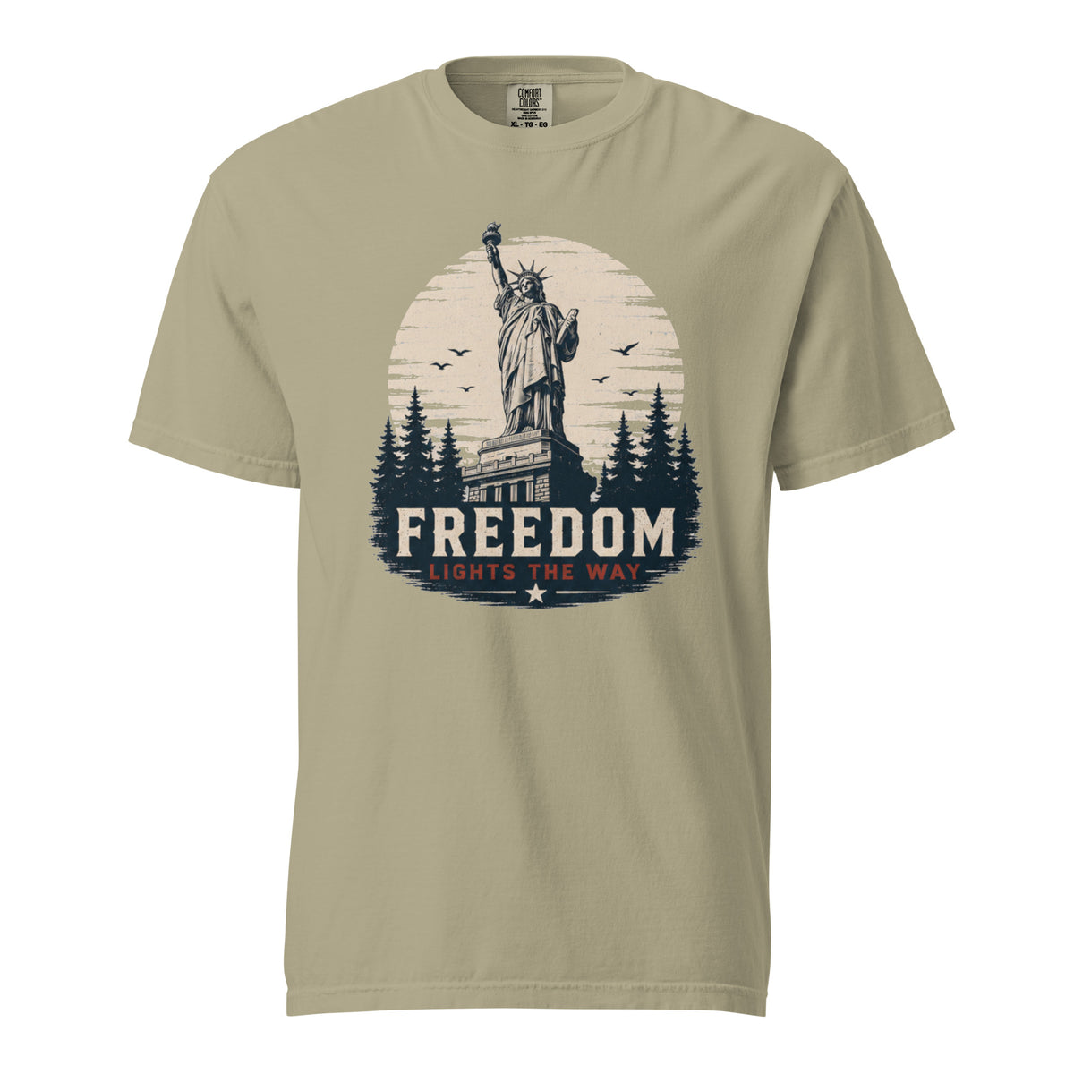 Tan men's t-shirt with statue of liberty and trees, that says "Freedom Lights the way" under it