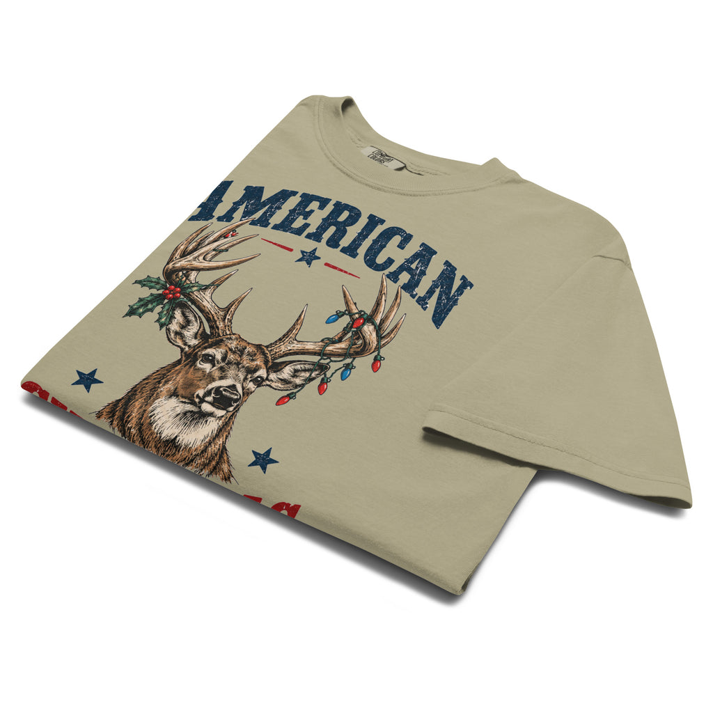 men's tan Christmas t-shirt that says "American Christmas" with a buck that has lights and holly on antlers