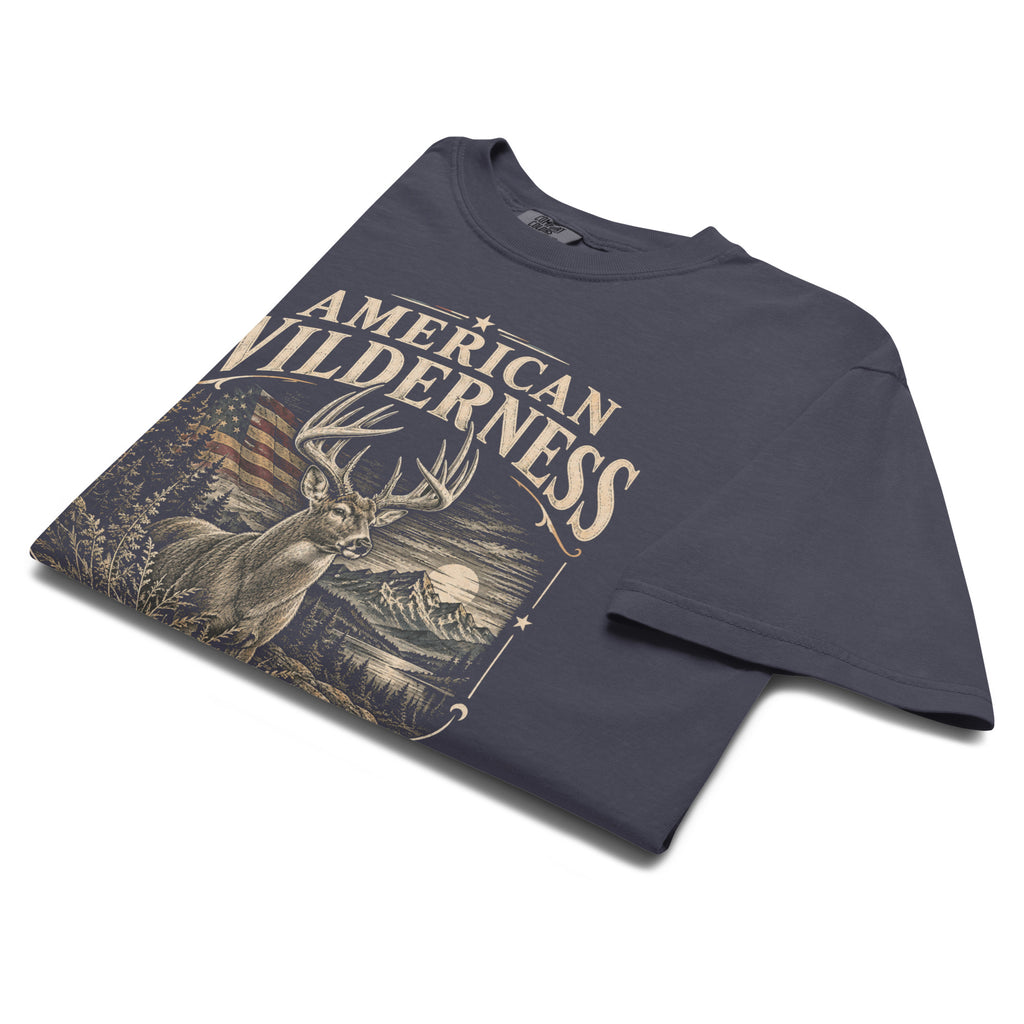 navy men's t-shirt with "American Wilderness" across the top, and a whitetail buck graphic with an American flag and small lettering along the bottom