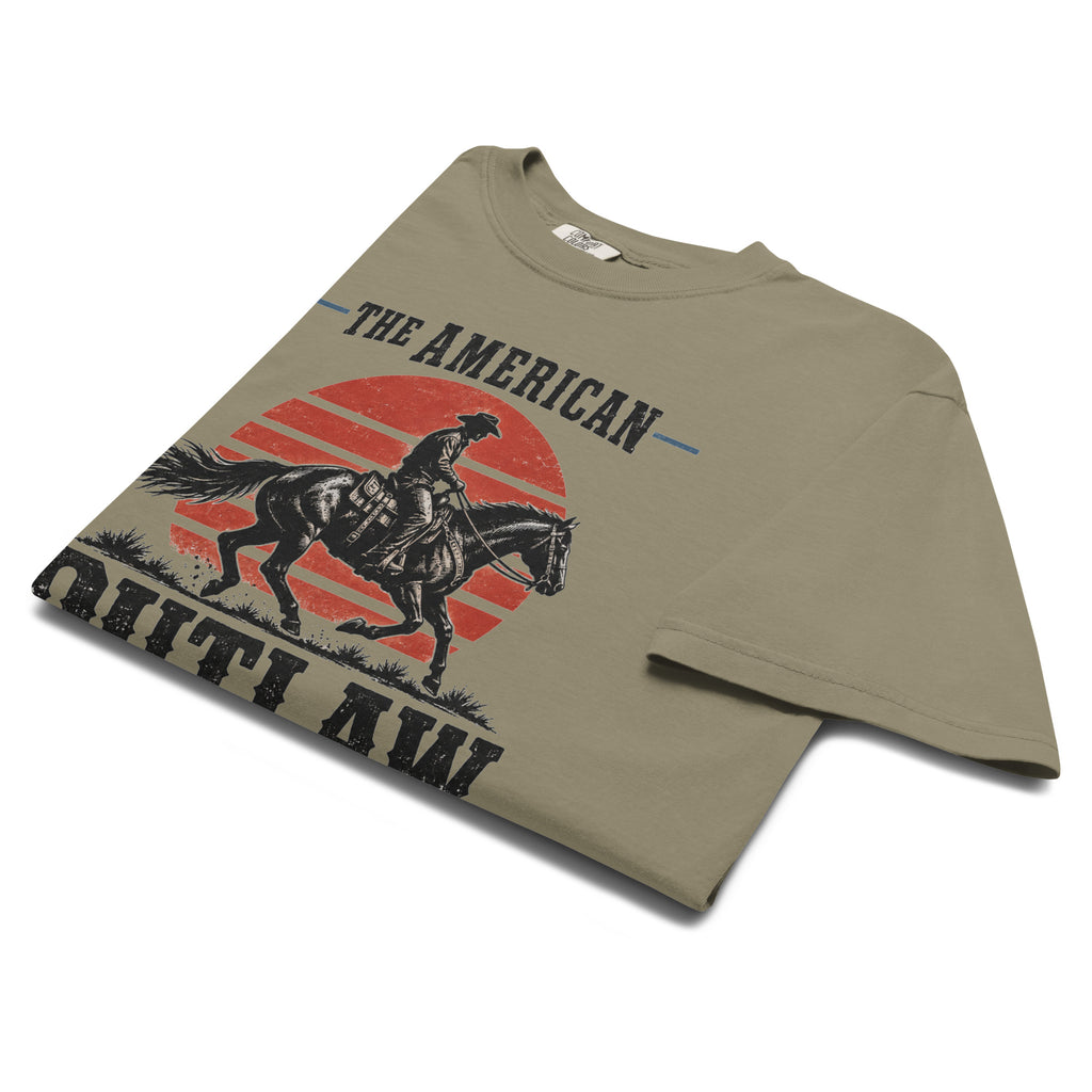 green men's t-shirt with a sun setting silhouette and cowboy riding horse with "The American Outlaw" written above and below