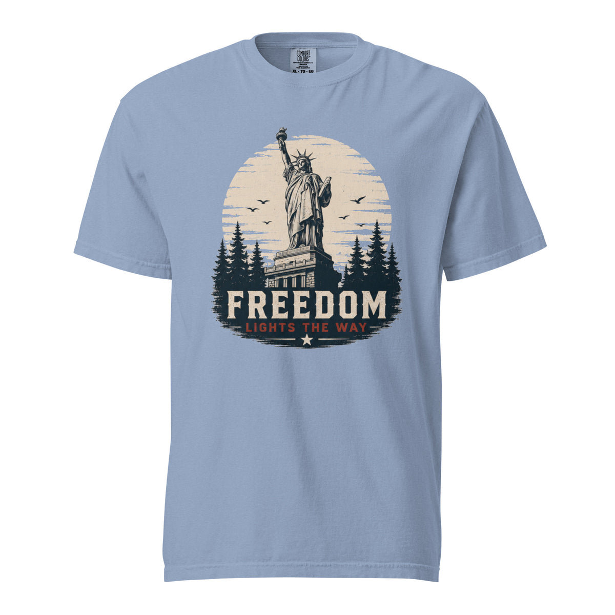 Blue men's t-shirt with statue of liberty and trees, that says "Freedom Lights the way" under it