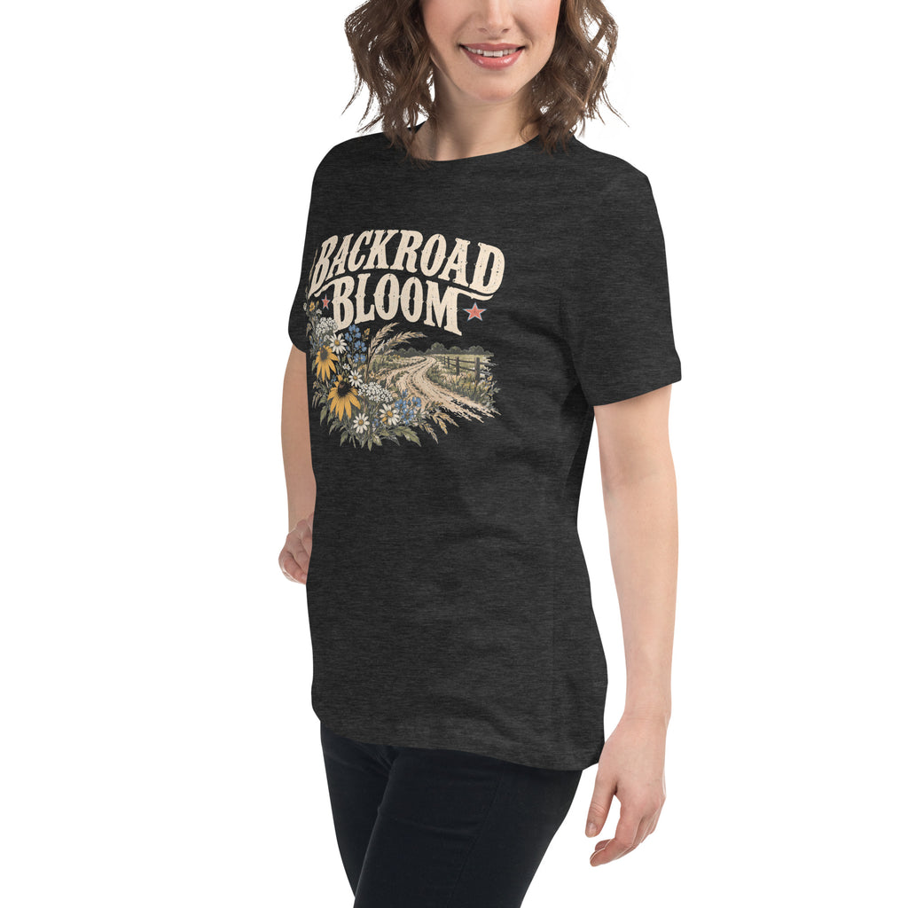 gray women's shirt with a wildflower graphic and dirt road below the text "backroad bloom"