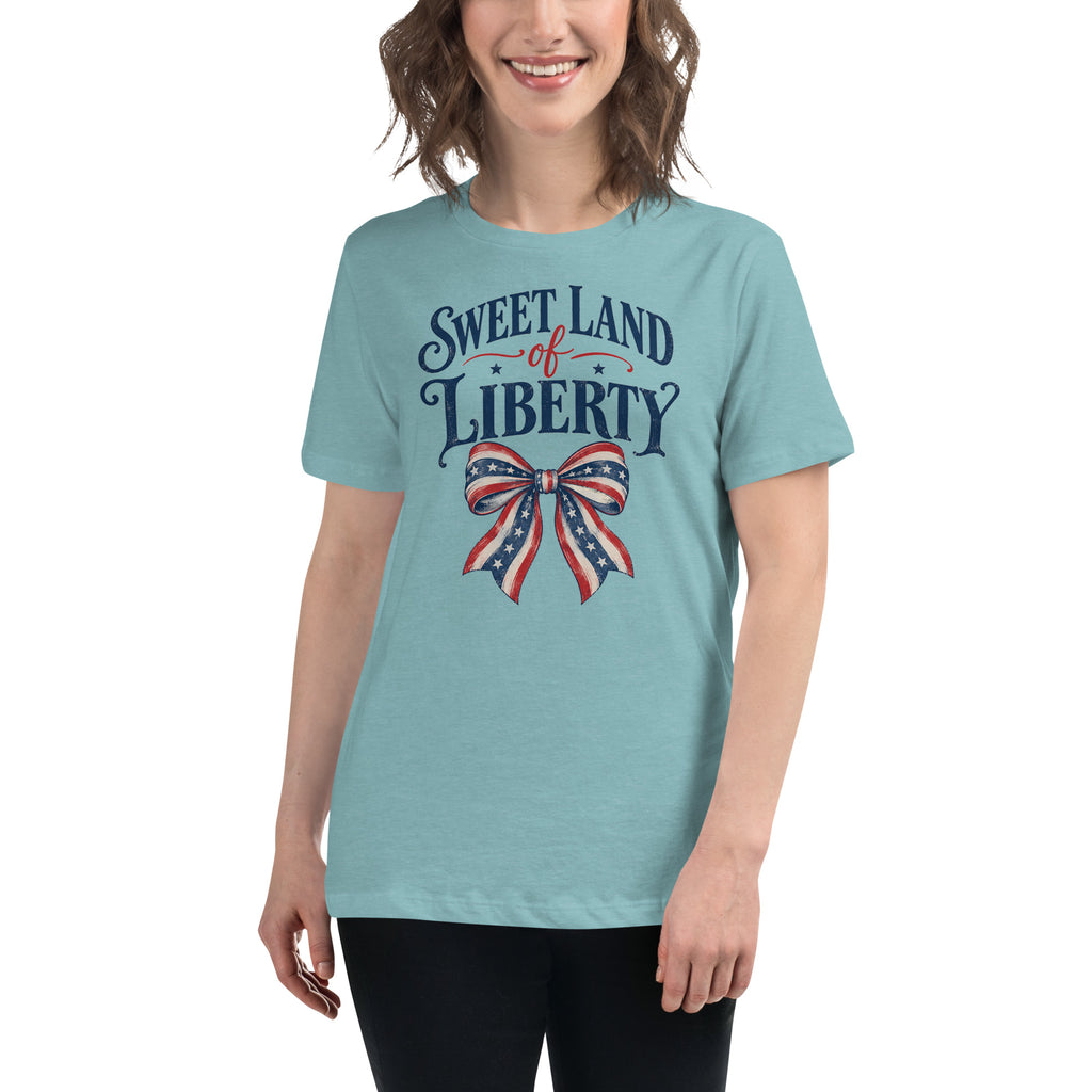 blue women's t-shirt with sweet land of liberty text written above a red, white and blue boutique bow