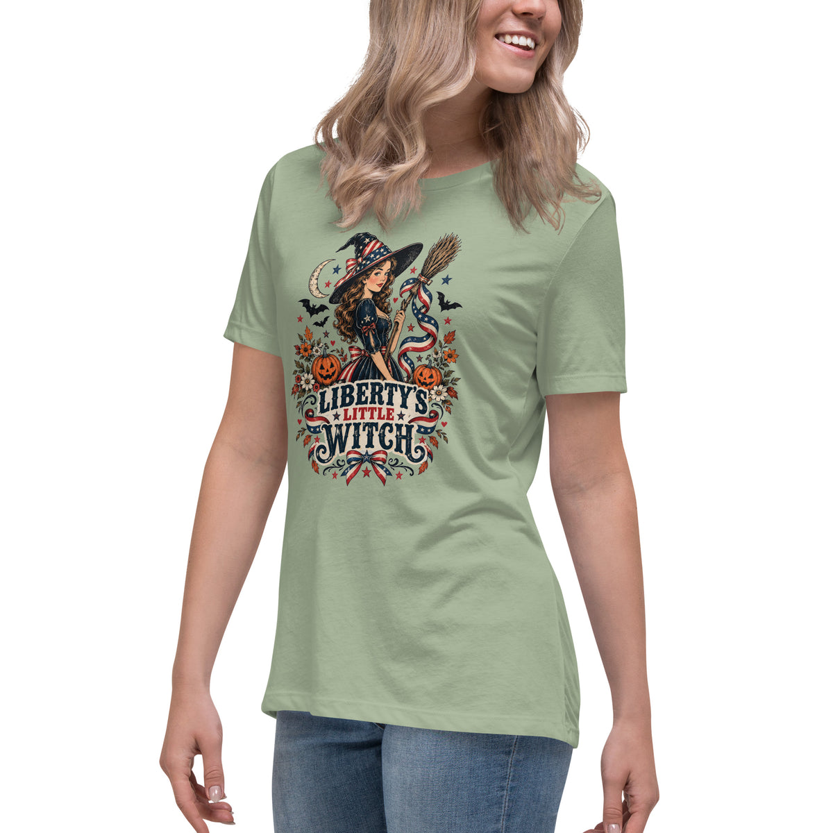 green women's shirt with American theme witch, and halloween/fall inspired small icons with text saying "Liberty's Little Witch"