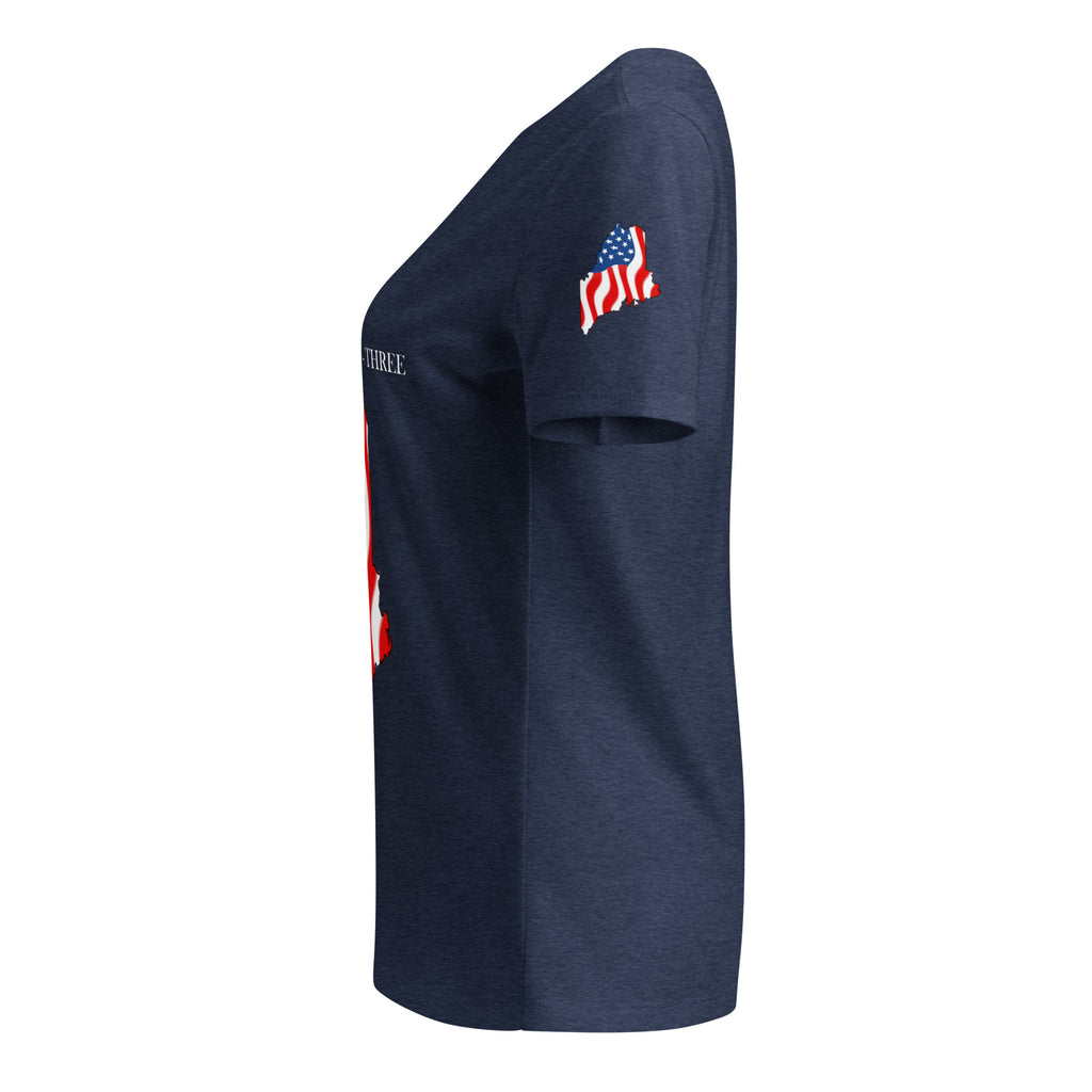 A navy blue heather short-sleeve t-shirt shown from a side profile view. The shirt features a small American flag graphic on the upper right sleeve (viewer's left) and a partial red and white graphic on the lower left side.