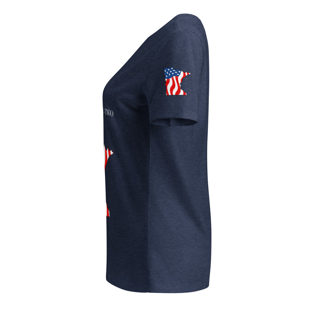A navy blue heather short-sleeve t-shirt shown from a side profile view against a solid white background. The shirt features a small graphic on the upper left sleeve depicting the state of Michigan filled with an American flag pattern, and partial white text on the front.